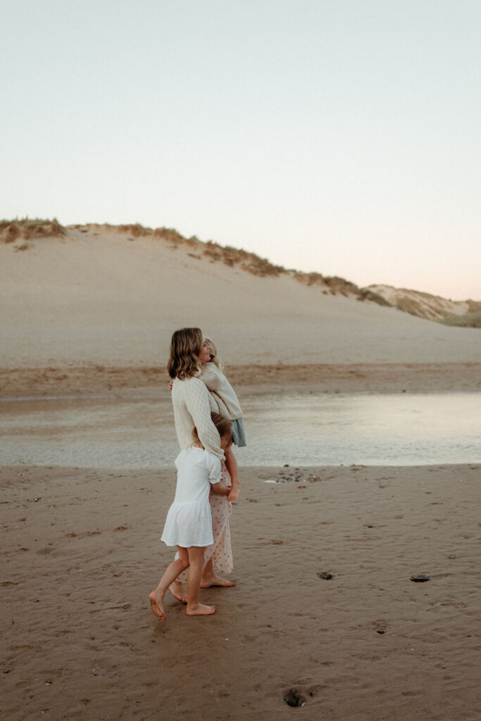 Portrait of Helen Mildmay and her children on the beach at sunset